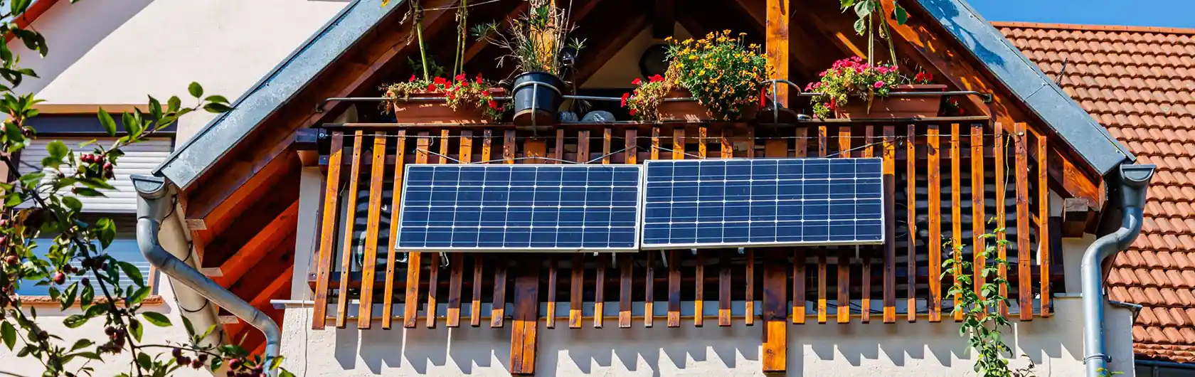 Ein farbenfroher Balkon mit Solarpanelen und Blumentöpfe.